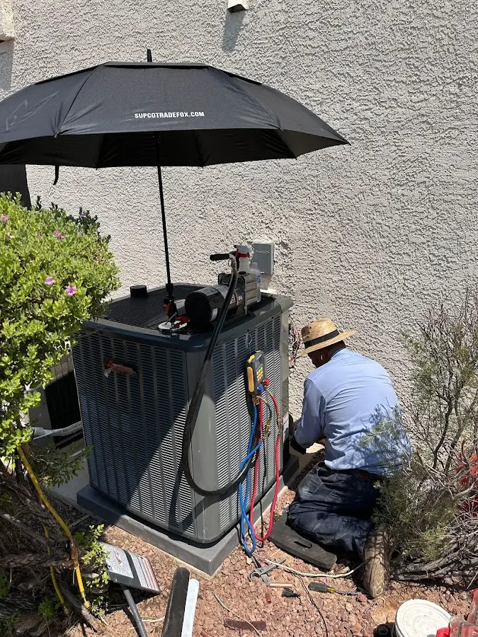 HVAC technician performing outdoor AC maintenance in Burrillville